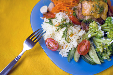 A plate of rice, meat  and vegetables