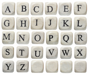 Alphabet letters on wooden pieces, isolated on white.