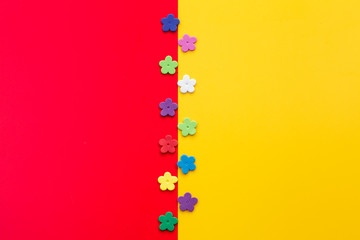 Colorful flowers on yellow-red background.