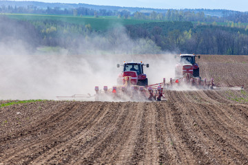 Naklejka premium Tractor harrowing the field