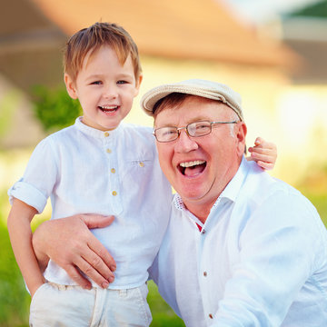 portrait of happy grandpa and grandson, outdoors