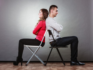 Young couple after quarrel sitting back to back