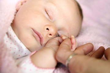 Sleeping Baby Girl Holding Mother's Hand