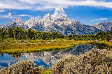 Fototapeta premium Scenic view of Grand Teton mountains with water reflection
