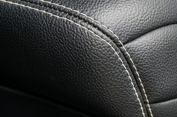 Modern business car interior detail. Leather background.