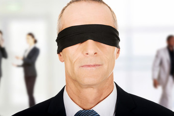 Businessman with band on eyes.