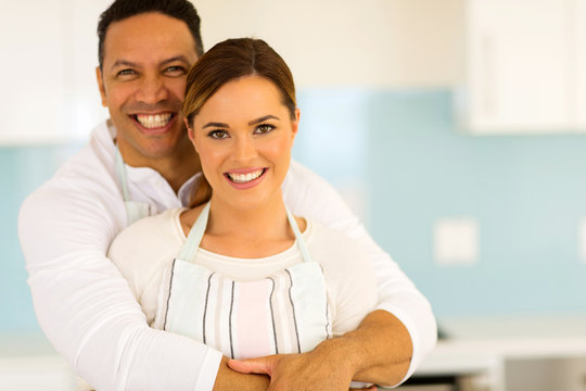 couple hugging in kitchen at home