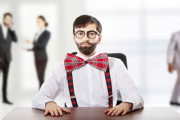 Young old fashioned man sitting by a desk.