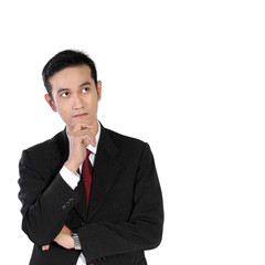 Young Asian businessman looking up thinking, isolated on white