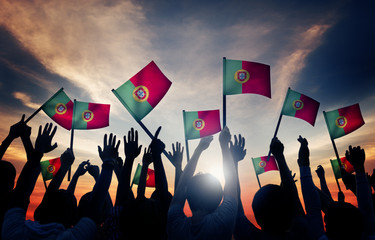 Group of People Waving Portuguese Flags in Back Lit