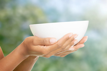 Woman's hands holding a bowl.