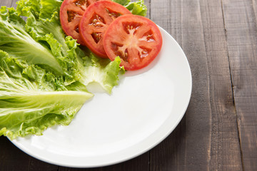 empty plate with tomatoes and vegetable waiting for food.