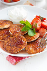 Pancakes with fresh strawberries on a plate, vertical