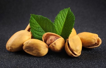 Pistachio nuts on a dark background