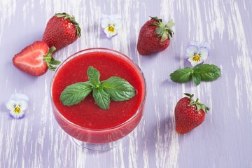 Strawberry jam on lilac background
