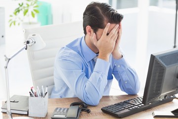 Upset businessman hiding his face