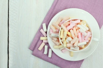 marshmallow in a cup on a wooden background