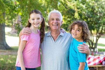 Extended family smiling in the park