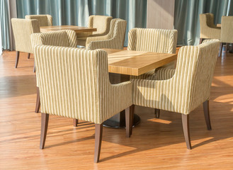 Tables and chairs on wooden floor.