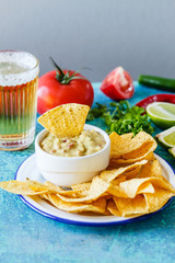 Guacamole with avocado, lime, tomato, and cilantro
