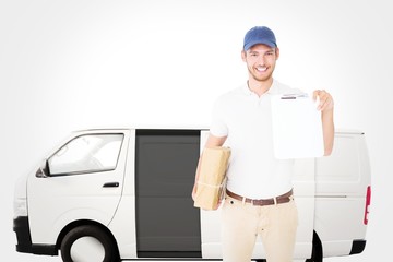 Delivery man holding cardboard box and  clipboard
