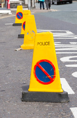 Symbol No parking on yellow traffic cone.