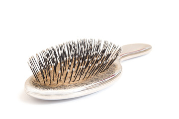 Close-up of an used hairbrush, isolated on white background