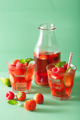 Fototapeta na wymiar summer strawberry raspberry lemonade with lime and mint