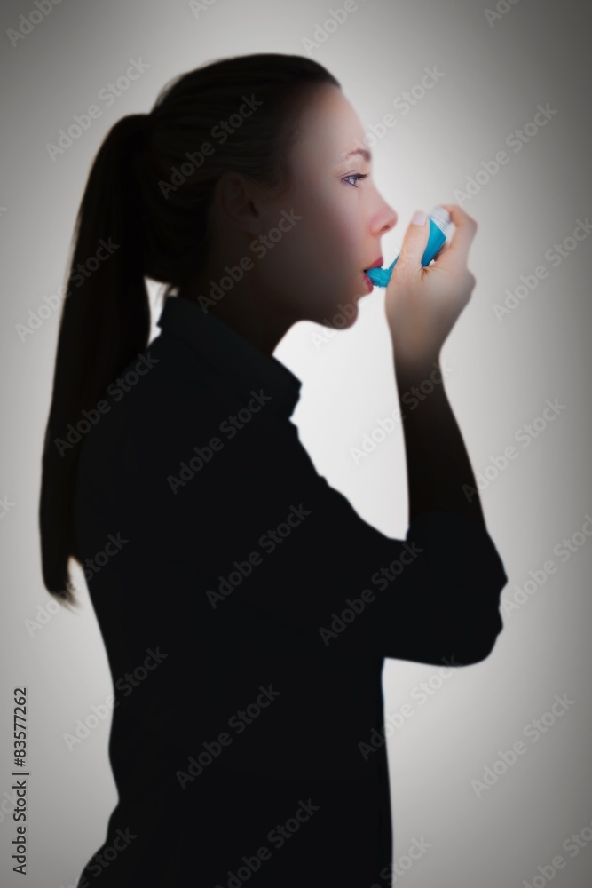Aufkleber composite image of beautiful blonde using an asthma inhaler