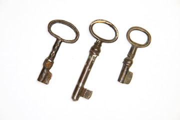 A lot vintage keys from the locks on a white background