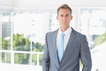 Fototapeta premium Serious businessman looking at camera