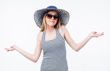 Happy woman in hat and sunglasses shrugging