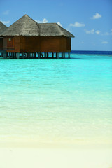 Water villas over ocean background