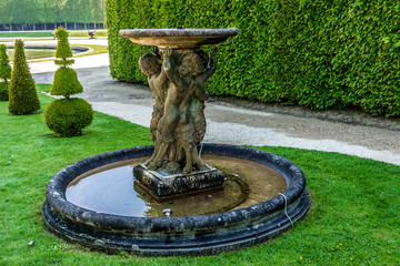 Fountain in beautiful gardens of famous Versailles palace.