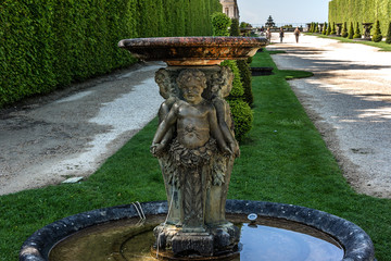 Fountain in beautiful gardens of famous Versailles palace.