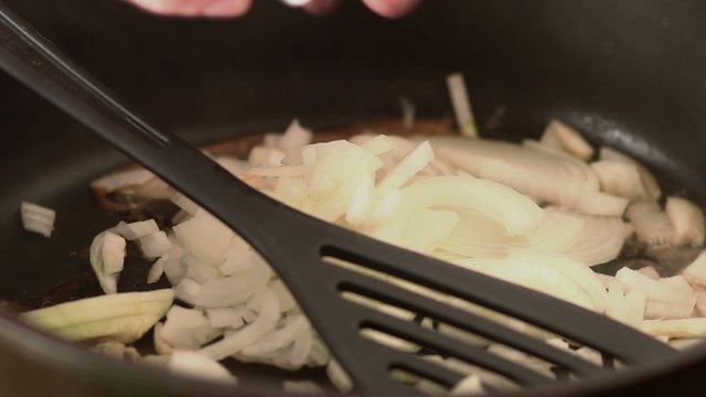 Chopped onions frying in hot pan - close up