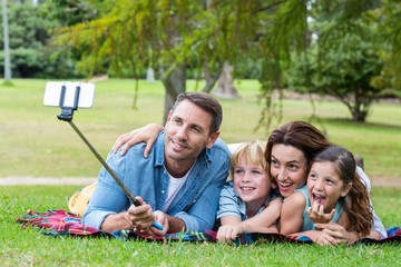 Fototapeta premium Happy family in the park taking selfie