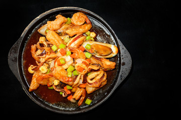 Seafood Prepared In A Frying Pan and black background