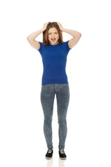 Fototapeta premium Frustrated young woman screaming.