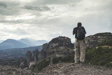 Man taking pictures in Meteora in Greece
