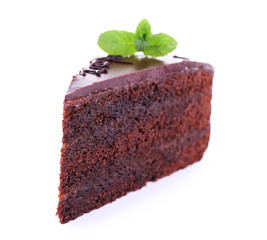 Piece of chocolate cake with mint isolated on white