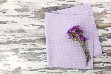 Beautiful dry flowers on napkin on wooden background - Powered by Adobe