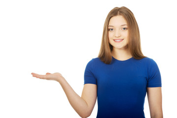 Smiling woman showing something on palm.