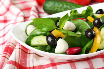 fresh vegetable salad in bowl on table close up