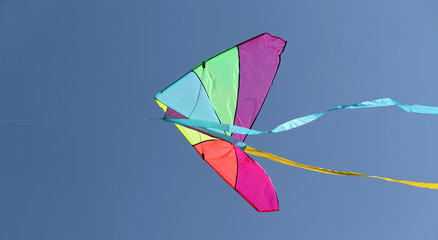 kite flying high in the sky blue