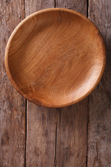 wooden plate on a rustic table closeup. vertical top view