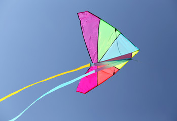 colorful kite flying high in the sky blue