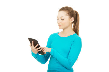 Naklejka premium Teenager using a tablet.