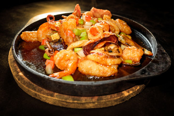 Seafood Prepared In A Frying Pan and black background