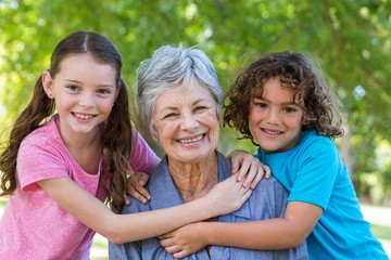 Extended family smiling and kissing in a park 